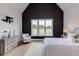 Charming main bedroom featuring a vaulted ceiling, dark accent wall, a window, and hardwood flooring at 15 Harvest View Way, Franklinton, NC 27525