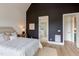 Comfortable main bedroom with an ensuite bathroom entrance, accent wall, and natural light at 15 Harvest View Way, Franklinton, NC 27525