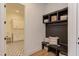 Mudroom with a built-in bench, cubbies, and decor with doorway access to the laundry room at 15 Harvest View Way, Franklinton, NC 27525