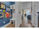 Hallway featuring custom built-ins, colorful artwork, and a glimpse of the kitchen, blending functionality and design at 1520 Rhodeschool Dr, Wendell, NC 27591