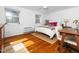 Bright bedroom featuring a double bed, a workspace, and hardwood floors at 1603 Sutton Dr, Raleigh, NC 27605