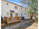 Charming townhome exterior showcases a wooden deck, complemented by lush greenery and a paved walkway at 1603 Sutton Dr, Raleigh, NC 27605