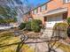 Charming brick two-story townhouse with manicured landscaping and inviting entrance with sunny sky overhead at 1603 Sutton Dr, Raleigh, NC 27605