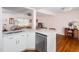 Open-concept kitchen with stainless steel appliances and quartz countertops, seamlessly connected to the living area at 1603 Sutton Dr, Raleigh, NC 27605