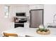 Bright kitchen featuring white cabinetry, stainless steel appliances, and stylish quartz countertops at 1603 Sutton Dr, Raleigh, NC 27605