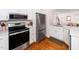 Well-equipped kitchen with stainless steel appliances, white cabinetry, and convenient access to the living area at 1603 Sutton Dr, Raleigh, NC 27605