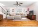 Open living space featuring hardwood floors, a plush sectional couch, and seamless flow at 1603 Sutton Dr, Raleigh, NC 27605