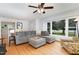 Comfortable living area with hardwood floors, a sectional sofa, and natural light streaming through the windows at 1807 S Mebane St, Burlington, NC 27215