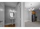 Bathroom featuring a pedestal sink with a decorative chandelier and a door to the kitchen at 201 Finsbury St # 302, Durham, NC 27703