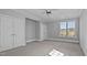 Bedroom featuring a closet, a door to an additional room, and natural light at 201 Finsbury St # 302, Durham, NC 27703