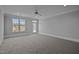 Bright and airy bedroom features plush carpeting, natural light, and a ceiling fan at 201 Finsbury St # 302, Durham, NC 27703