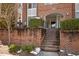 Inviting entryway with brick stairs, lush greenery, and clear signage at 201 Finsbury St # 302, Durham, NC 27703