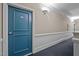 Hallway leading to unit featuring neutral walls and blue door with unit number at 201 Finsbury St # 302, Durham, NC 27703