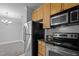 Modern kitchen with stainless steel appliances with an open view to the carpeted living room at 201 Finsbury St # 302, Durham, NC 27703