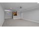 Open-concept living space with plush carpeting connecting to a kitchen area at 201 Finsbury St # 302, Durham, NC 27703