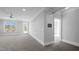 Bright living room with a ceiling fan, windows, and a door to the outside at 201 Finsbury St # 302, Durham, NC 27703