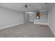 Spacious living room with neutral carpeting and trim detail leading to kitchen at 201 Finsbury St # 302, Durham, NC 27703