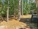 Backyard with mature trees offering privacy near a screened-in porch and deck at 208 Hardwood Ridge Ct, Clayton, NC 27520