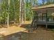 Shaded backyard featuring mature trees, a screened-in porch, and natural surroundings at 208 Hardwood Ridge Ct, Clayton, NC 27520