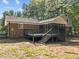 Backyard view showing a deck, trees, and the exterior of the home at 208 Hardwood Ridge Ct, Clayton, NC 27520