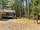 Backyard with pine trees, a deck, and a screened-in porch at 208 Hardwood Ridge Ct, Clayton, NC 27520