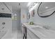 Bathroom features a double vanity with granite countertop, modern fixtures, and decorative mirrors at 208 Hardwood Ridge Ct, Clayton, NC 27520