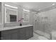 Bright bathroom with double vanity, modern fixtures, and glass-enclosed shower at 208 Hardwood Ridge Ct, Clayton, NC 27520