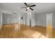 Spacious bedroom with hardwood floors, large window, and ceiling fan at 208 Hardwood Ridge Ct, Clayton, NC 27520