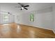 Spacious bedroom with hardwood floors, three windows, and two ceiling fans at 208 Hardwood Ridge Ct, Clayton, NC 27520