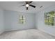 Light blue bedroom featuring plush carpet and two windows at 208 Hardwood Ridge Ct, Clayton, NC 27520