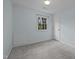 Cozy bedroom with light blue walls, neutral carpet, a window, and white trim at 208 Hardwood Ridge Ct, Clayton, NC 27520