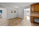 Dining room with tile floors adjacent to kitchen with natural light and open layout at 208 Hardwood Ridge Ct, Clayton, NC 27520