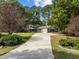 Charming brick home with attached garage, long driveway, and lush landscaping at 208 Hardwood Ridge Ct, Clayton, NC 27520