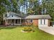 Charming brick home with well-maintained landscaping and a welcoming front porch at 208 Hardwood Ridge Ct, Clayton, NC 27520