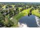 Scenic aerial view of a lush golf course with a pond and manicured greens at 208 Hardwood Ridge Ct, Clayton, NC 27520