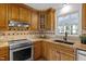 Well-lit kitchen features custom wood cabinets, granite countertops, stainless steel appliances, and decorative backsplash at 208 Hardwood Ridge Ct, Clayton, NC 27520