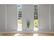 Bright room featuring hardwood floors, large windows, and a decorative plant at 208 Hardwood Ridge Ct, Clayton, NC 27520