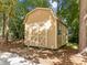 Backyard shed with double doors and a single window, offering outdoor storage at 208 Hardwood Ridge Ct, Clayton, NC 27520