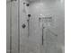 Modern tiled shower featuring multiple shower heads, glass door, and grab bar at 208 Hardwood Ridge Ct, Clayton, NC 27520