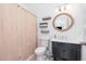 Cozy bathroom featuring a vanity with storage, updated fixtures, and neutral shower curtain at 214 Woodcrest Ave, Smithfield, NC 27577