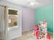 Bright bedroom with colorful walls and natural light from the window at 214 Woodcrest Ave, Smithfield, NC 27577