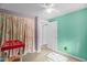 Bright bedroom featuring a colorful accent wall, plush carpet, and a ceiling fan for added comfort at 214 Woodcrest Ave, Smithfield, NC 27577