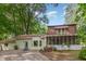 Exterior view of home showcasing screened-in porch and lush landscaping at 214 Woodcrest Ave, Smithfield, NC 27577