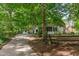 Home with long driveway, screened porch, and lush, mature trees at 214 Woodcrest Ave, Smithfield, NC 27577