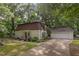 Charming two-story home with lush landscaping and a detached garage at 214 Woodcrest Ave, Smithfield, NC 27577