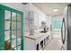 Bright kitchen with white cabinets, stainless steel appliances, and a green-framed glass door at 214 Woodcrest Ave, Smithfield, NC 27577
