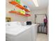 Functional laundry room with washer, dryer, and shelving for optimal organization at 214 Woodcrest Ave, Smithfield, NC 27577