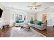 Bright living room with large windows, hardwood floors, and neutral decor at 214 Woodcrest Ave, Smithfield, NC 27577