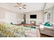 Cozy living room featuring a ceiling fan, paneled walls, and hardwood flooring at 214 Woodcrest Ave, Smithfield, NC 27577