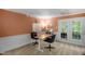Functional office space with natural lighting, modern desk, and view to the exterior at 214 Woodcrest Ave, Smithfield, NC 27577